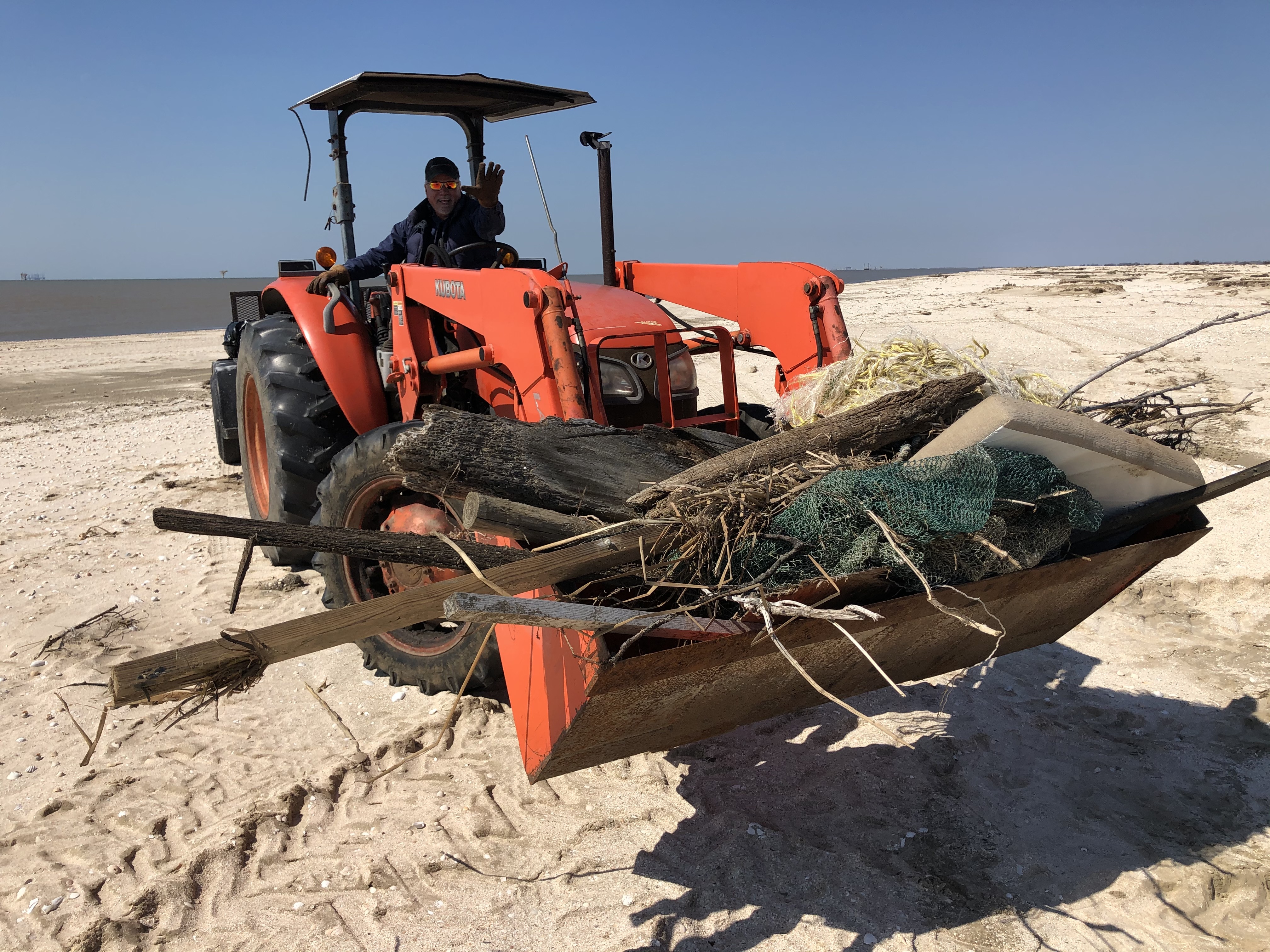 Cameron Parish President and Police Juror for District 5, Scott Trahan, removes large debris from Rutherford Beach with the help of his tractor. Katie Barnes/Audubon Louisiana
