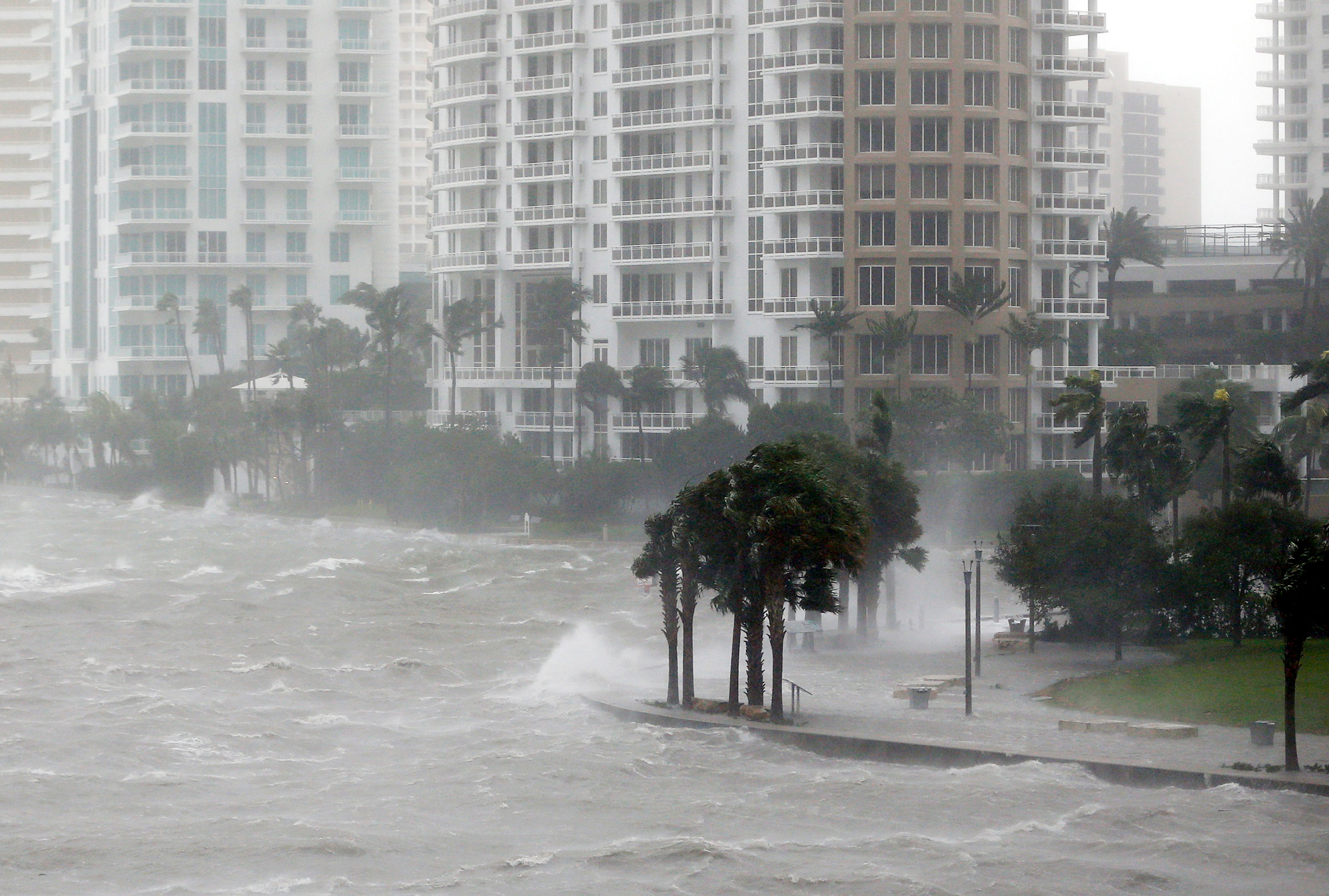 Waves crash over a seawall at the mouth of the Miami River from Biscayne Bay, FL, as Hurricane Irma passed through Miami in September 2017. Stronger hurricanes are one impact of rising global temperatures. Wilfredo Lee/AP
