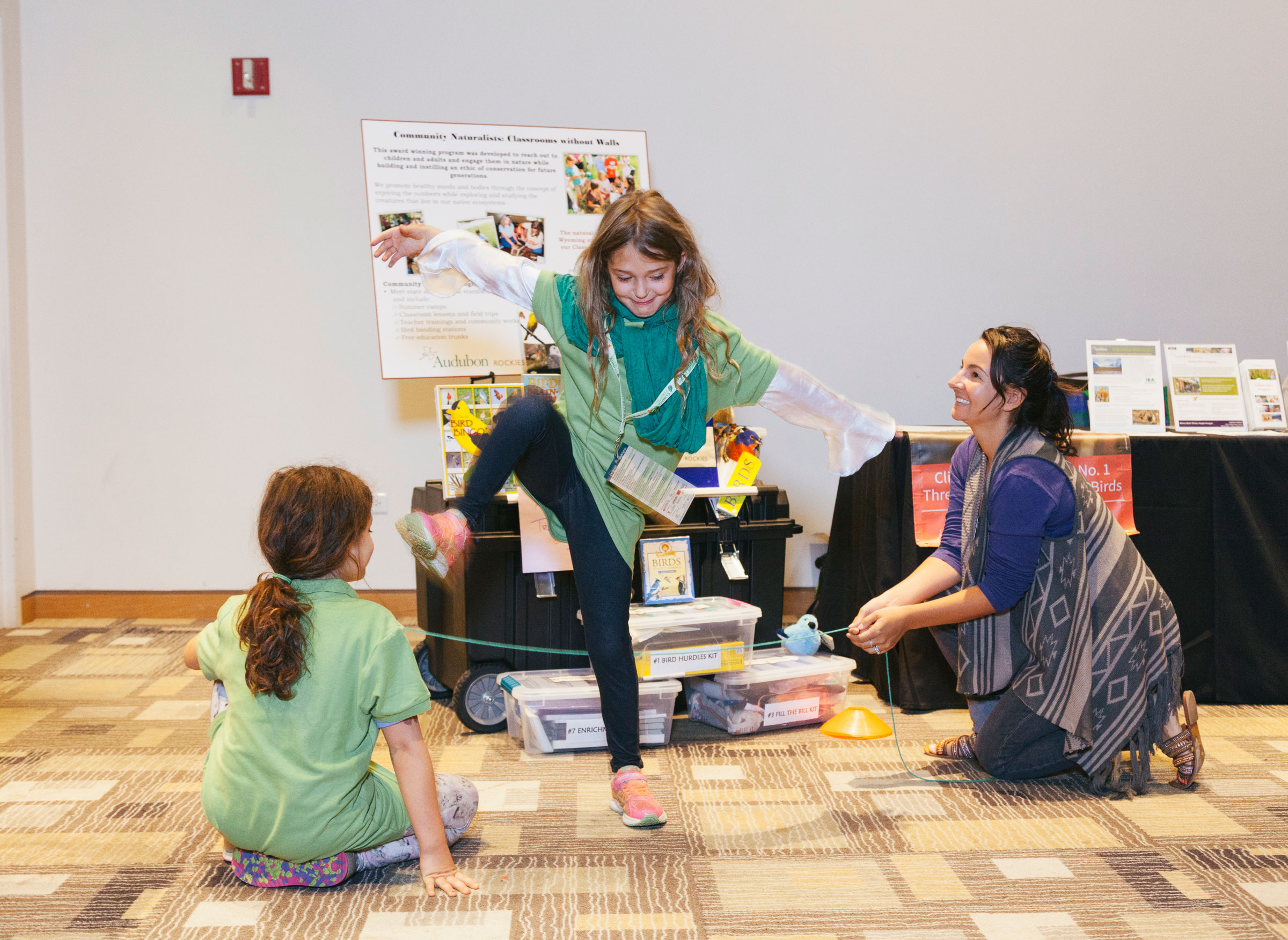 Two visitors participate in an activity from Audubon Rockies' "Bird Hurdle Kit," one of many learning games in the Birds and Climate Educational Traveling Trunk. Morgan Rachel Levy