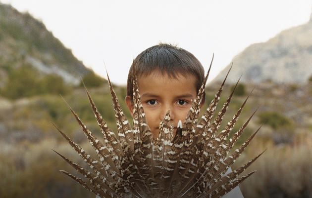 Andrew_Geiger_Time_to_Act. A young resident of Wyoming's Wind River reservation holds Sage-Grouse tail feathers. Andrew Geiger