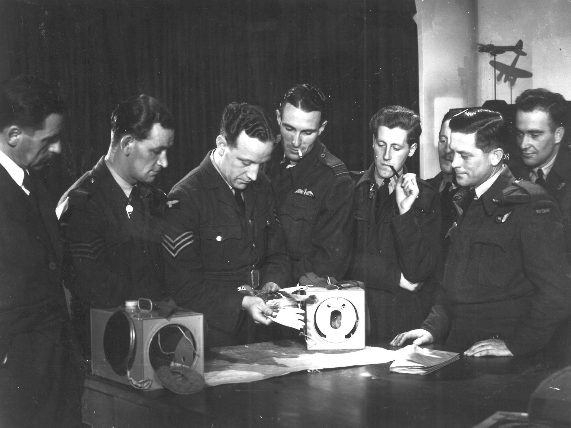 Many pigeons were dropped by aircrews to deliver messages to troops on the ground. Here, aircrews are trained in the correct deployment of the plucky birds. AR/BNPS