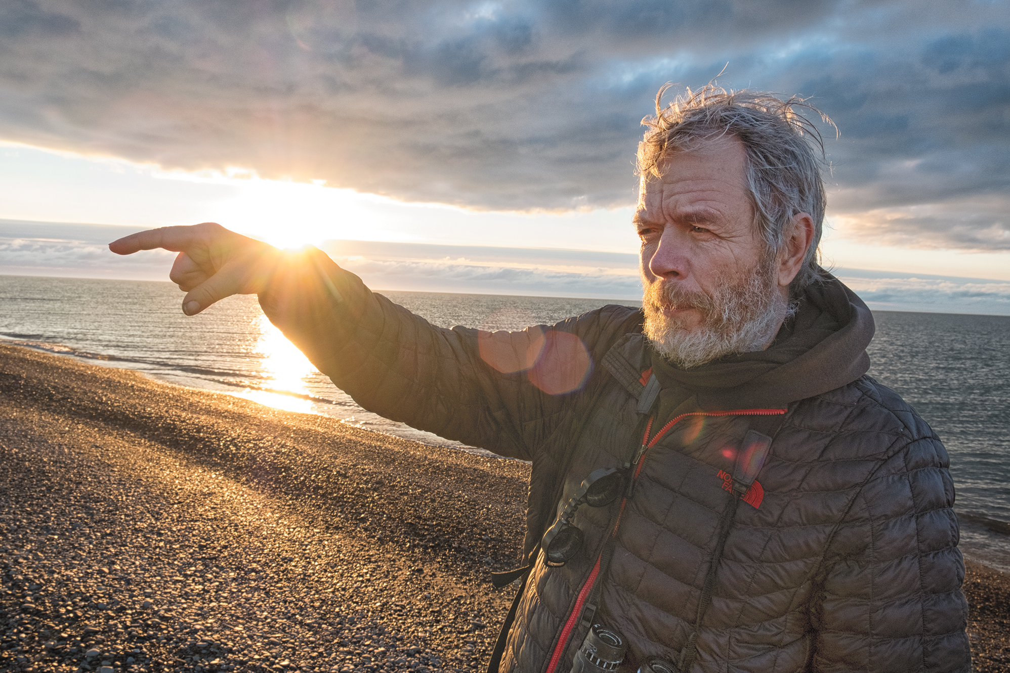 George Divoky gestures by the light of Alaska's midnight sun on Cooper Island. Peter Mather