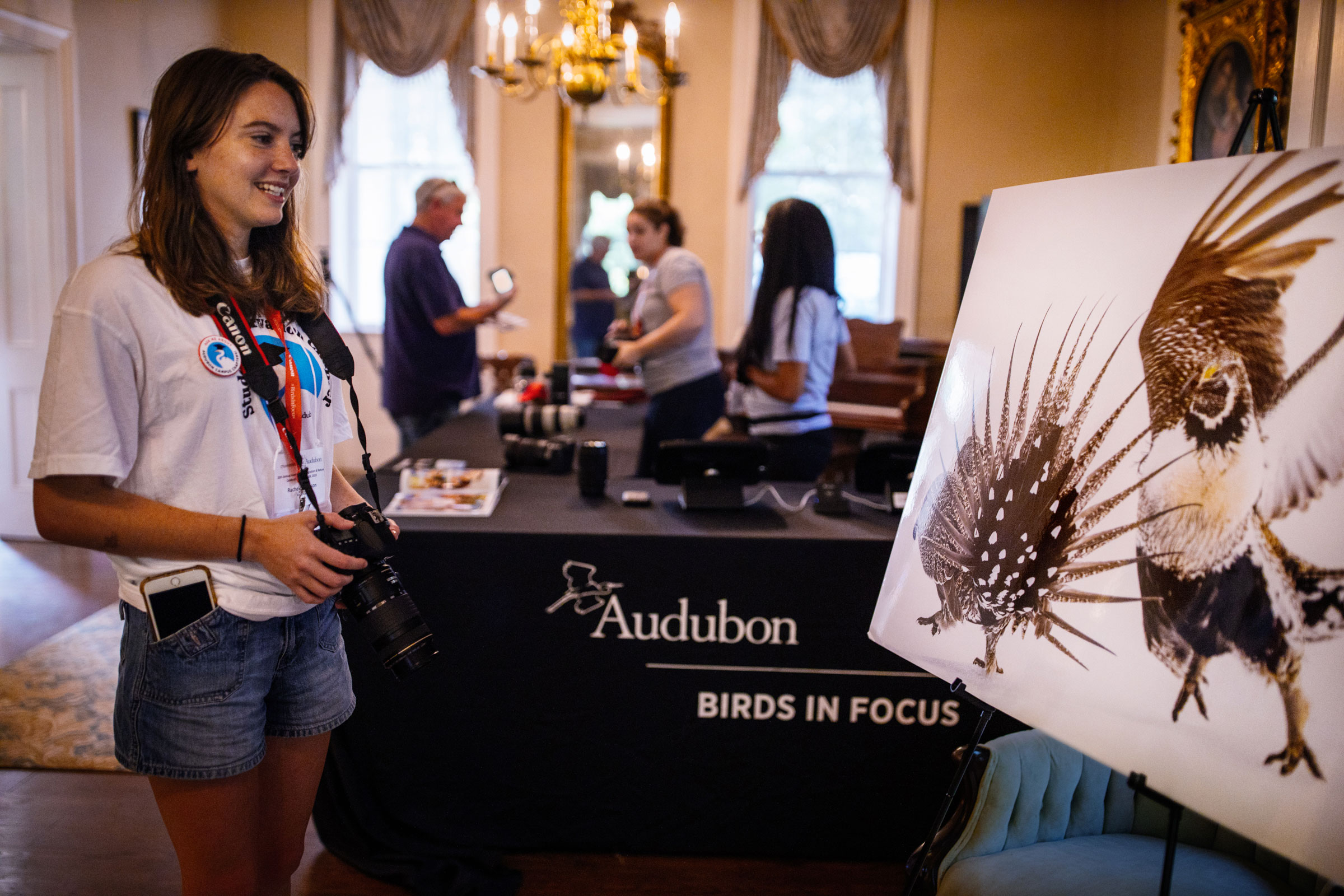Rachel Anderson, president of the Magnolia Grove Audubon campus chapter at the University of Mississippi, admires the Audubon Photography Awards exhibit at the Strawberry Plains Hummingbird Festival. Mike Fernandez/Audubon