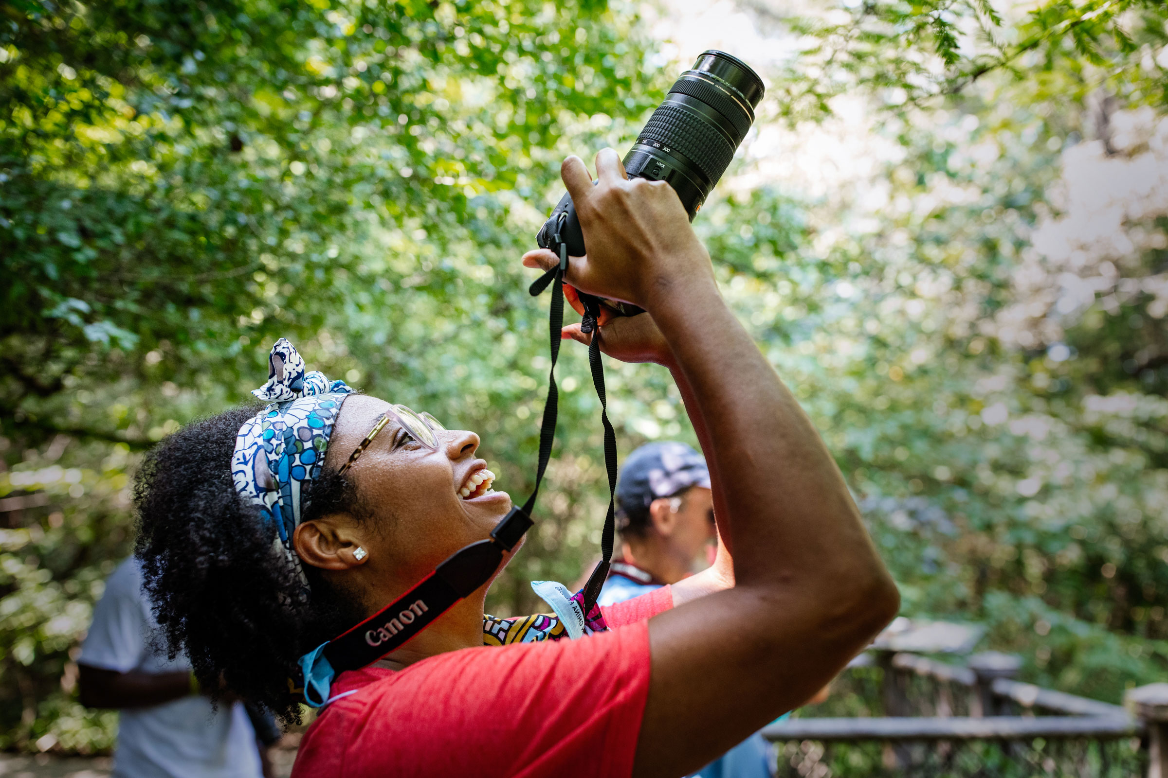 Anna Scott, faculty advisor for the Birds of a Feather Audubon campus chapter at Rust College, tests out a Canon camera during a "Birds in Focus" walk. Mike Fernandez/Audubon