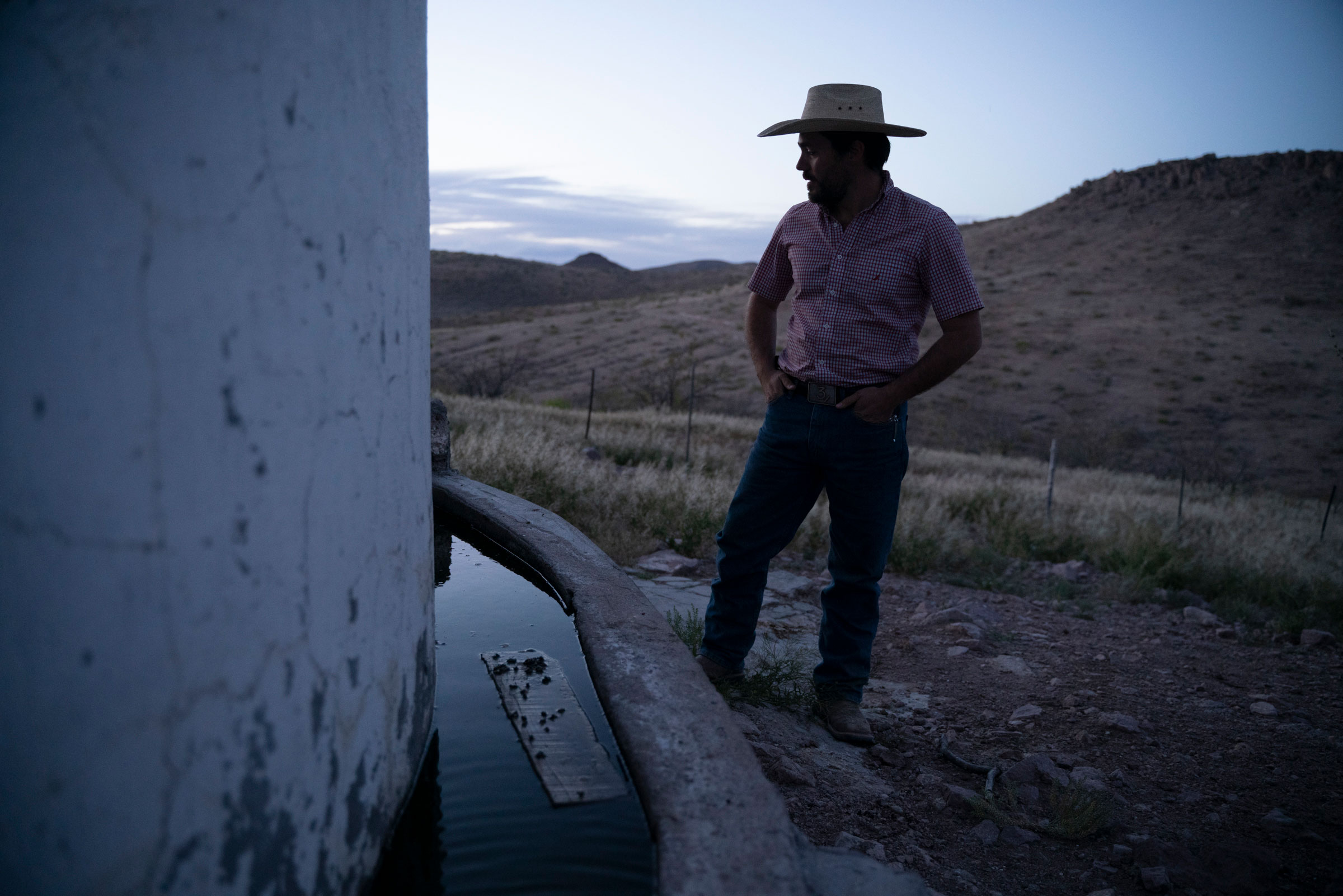 Enrique Perez Carrillo, 31, checks the water level of a water tank on his ranch. Paul Ratje