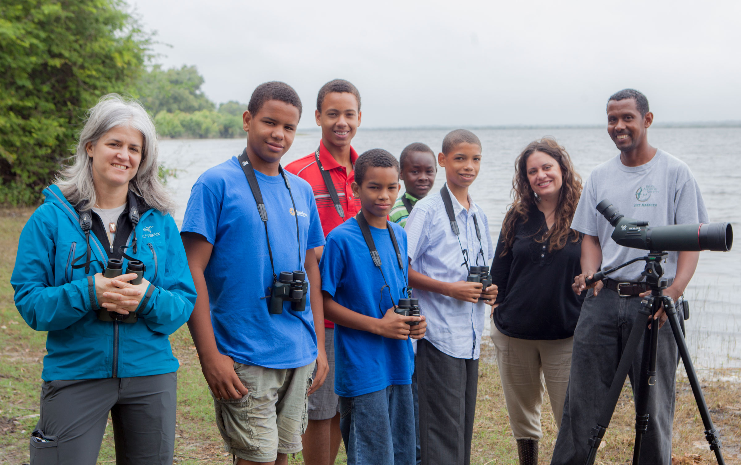 From left: Brand, Dayna Reggero of the Climate Listening Project, and Derick Hendy of Belize Audubon Society with the Crooked Tree Wildlife Sanctuary Junior Bird Club. Andrea Desky/Climate Listening Project