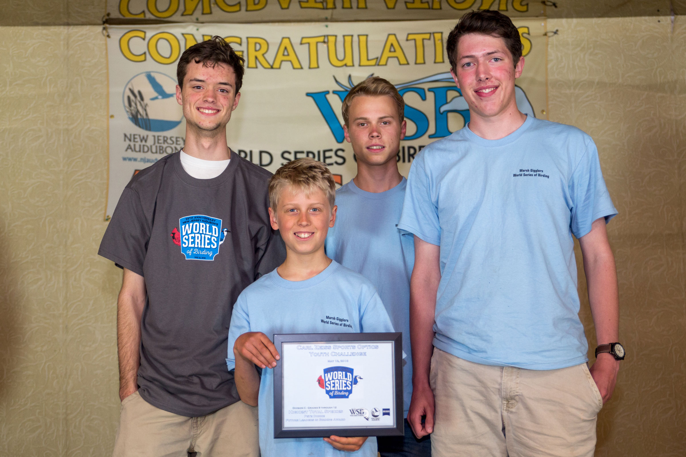 Joshua Heiser, Jonathan Irons, Daniel Irons, and Patrick Newcombe hold up their winning plaque at the awards brunch at the Cape May Inn. Camilla Cerea/Audubon